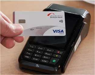 Boubyan card touches POS device to pay the bill by UTap feature using NFC