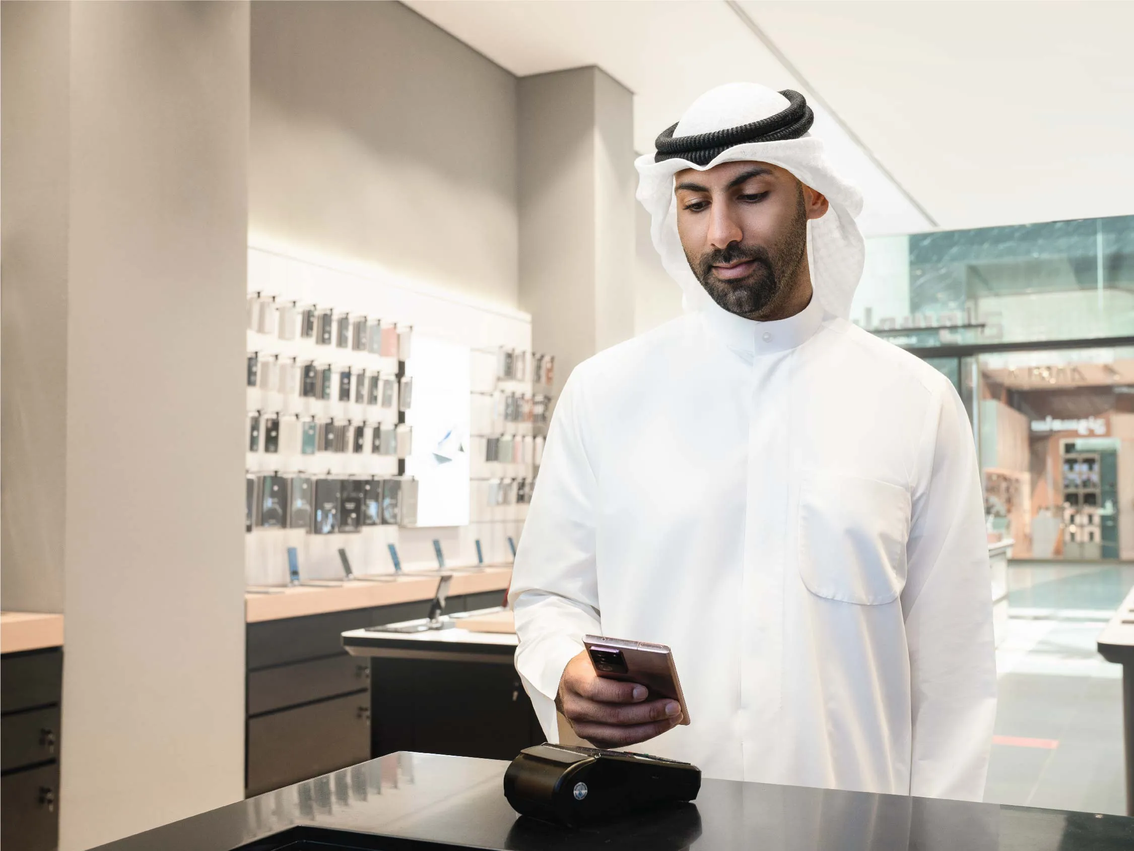 A person making a payment through Samsung Pay using NFC technology