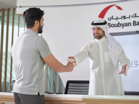 Boubyan Bank official offering Sharia-compliant savings account to a customer