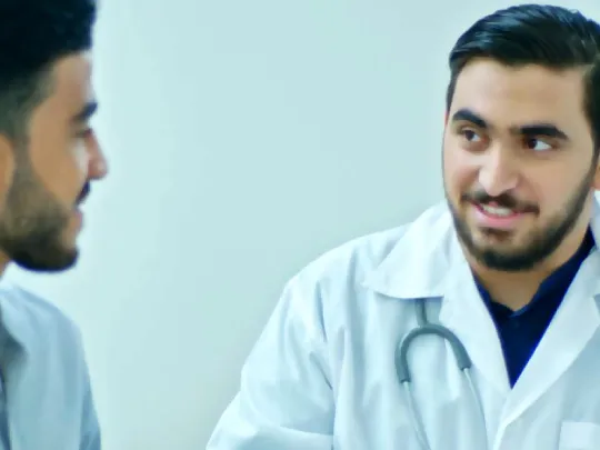 A physician explains to a patient the benefits of Boubyan Bank's health financing.