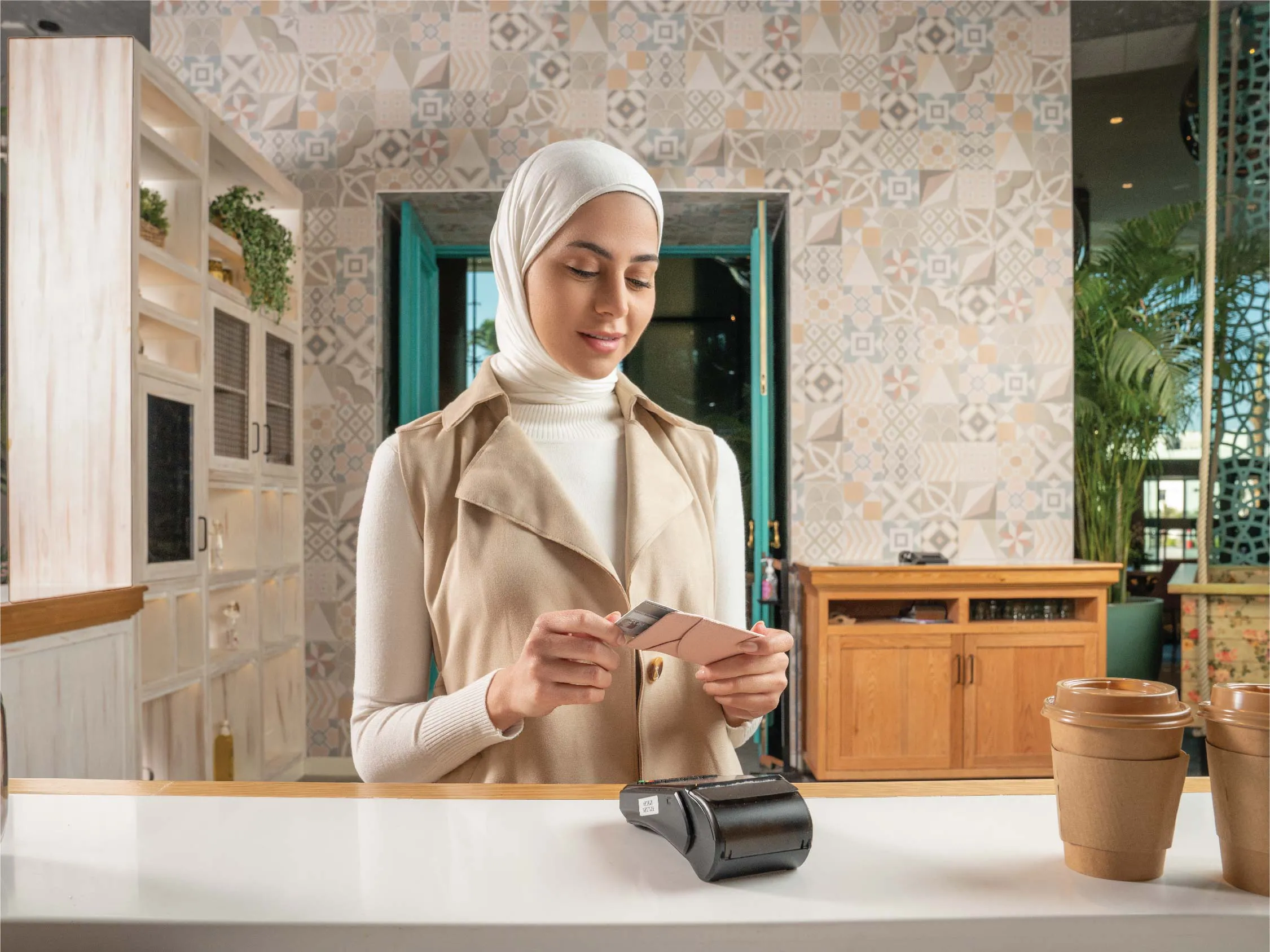 A woman making purchases with Boubyan's prepaid card