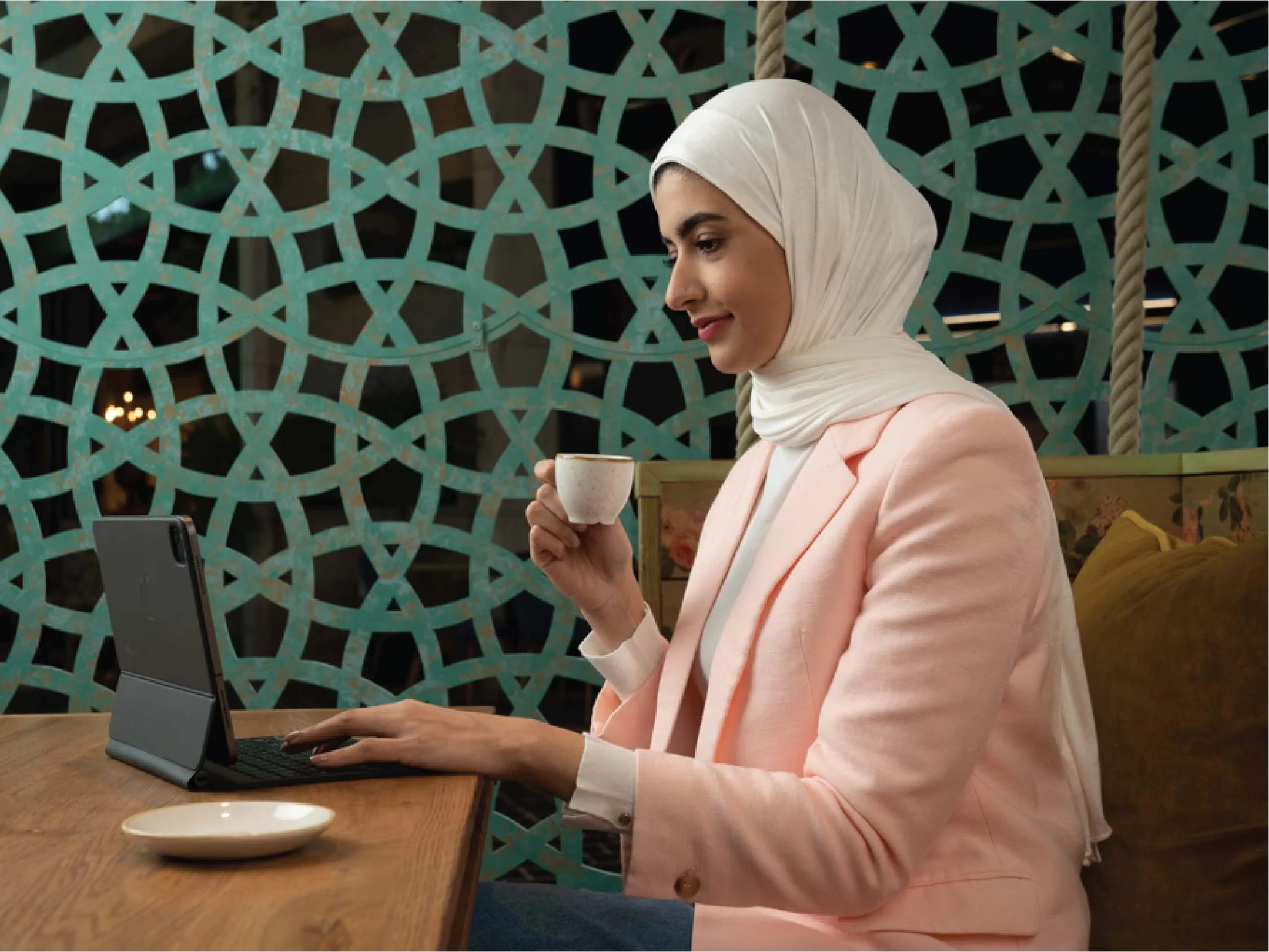 A woman shopping securely online using Boubyan Bank's Visa Checkout service