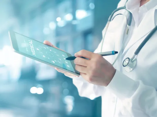 A doctor accessing the types of treatment and medical services covered under Boubyan Health Finance.