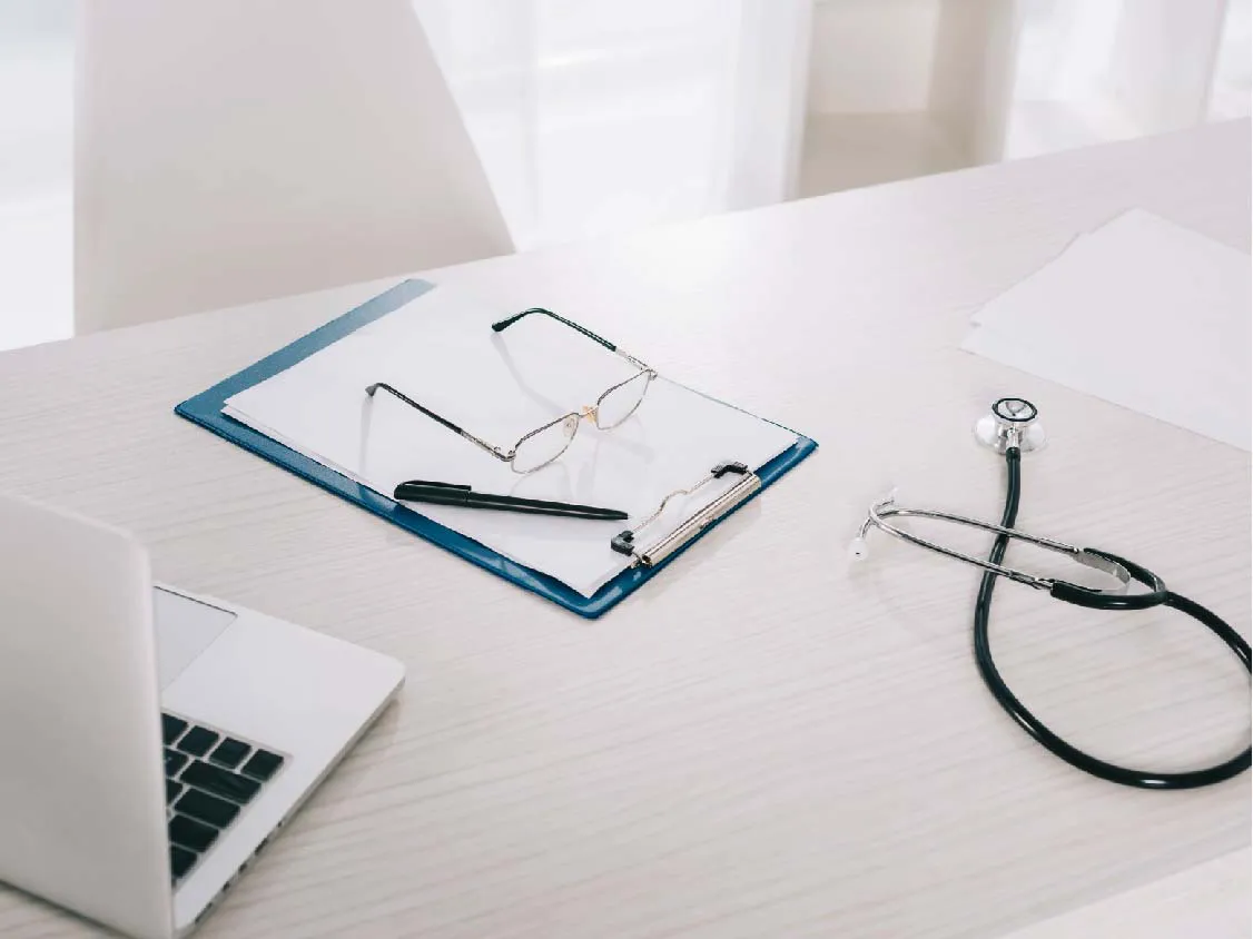 Stethoscope and prescription reports kept on a doctor's desk.