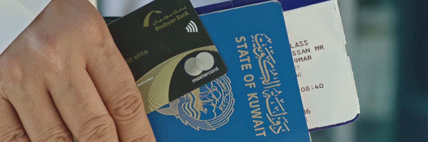 A businessperson carrying Kuwait's passport and a MasterCard World Elite Credit Card