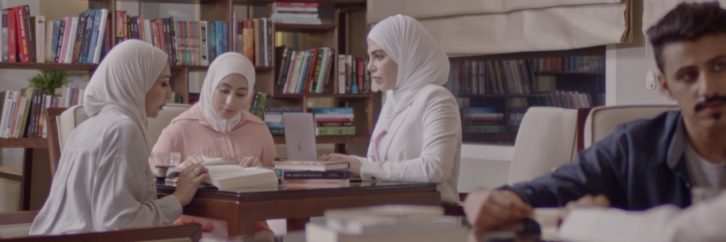 CLICK students studying in a University library طلاب يدرسون في مكتبة الجامعة