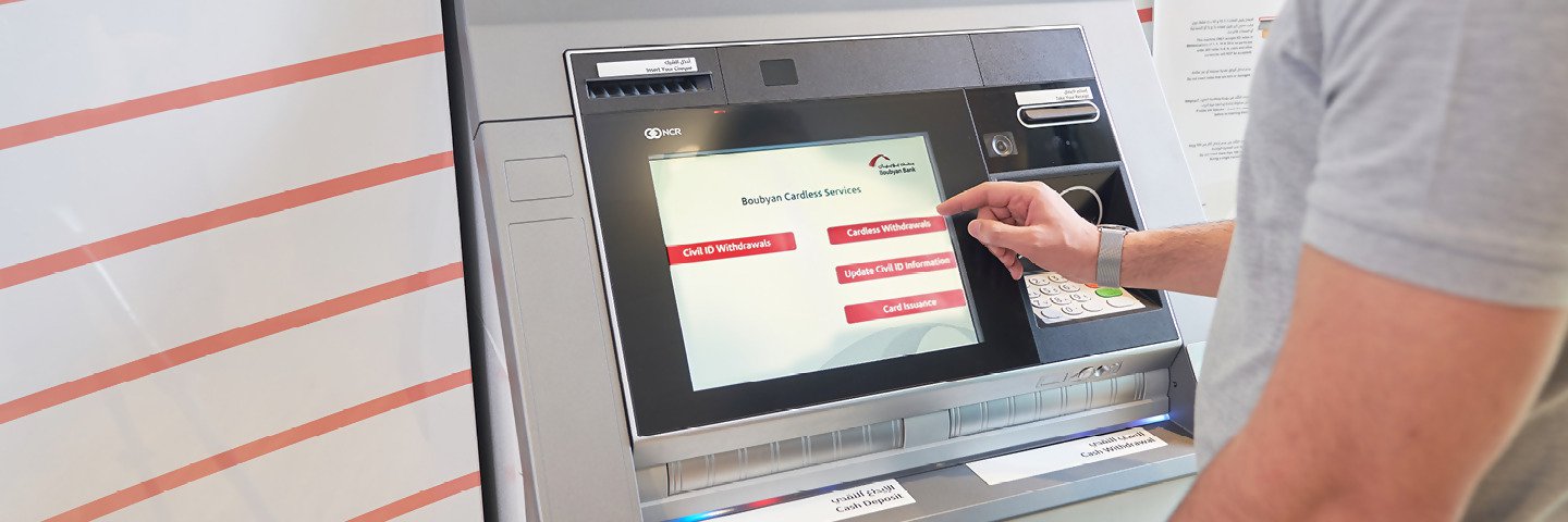 A customer uses the cardless withdrawal service at a Boubyan Bank ATM to withdraw money